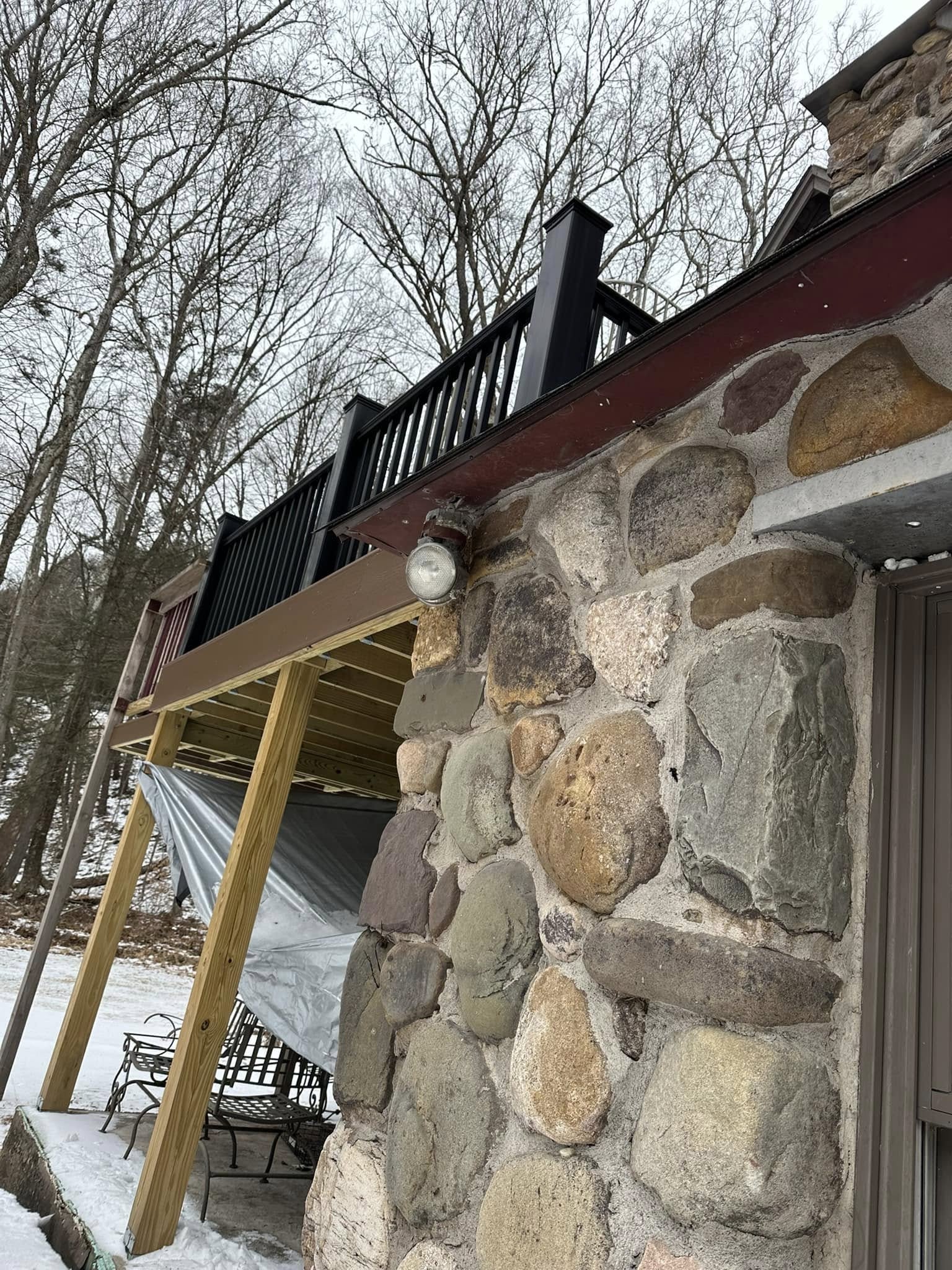 Custom deck with integrated stone retaining wall.