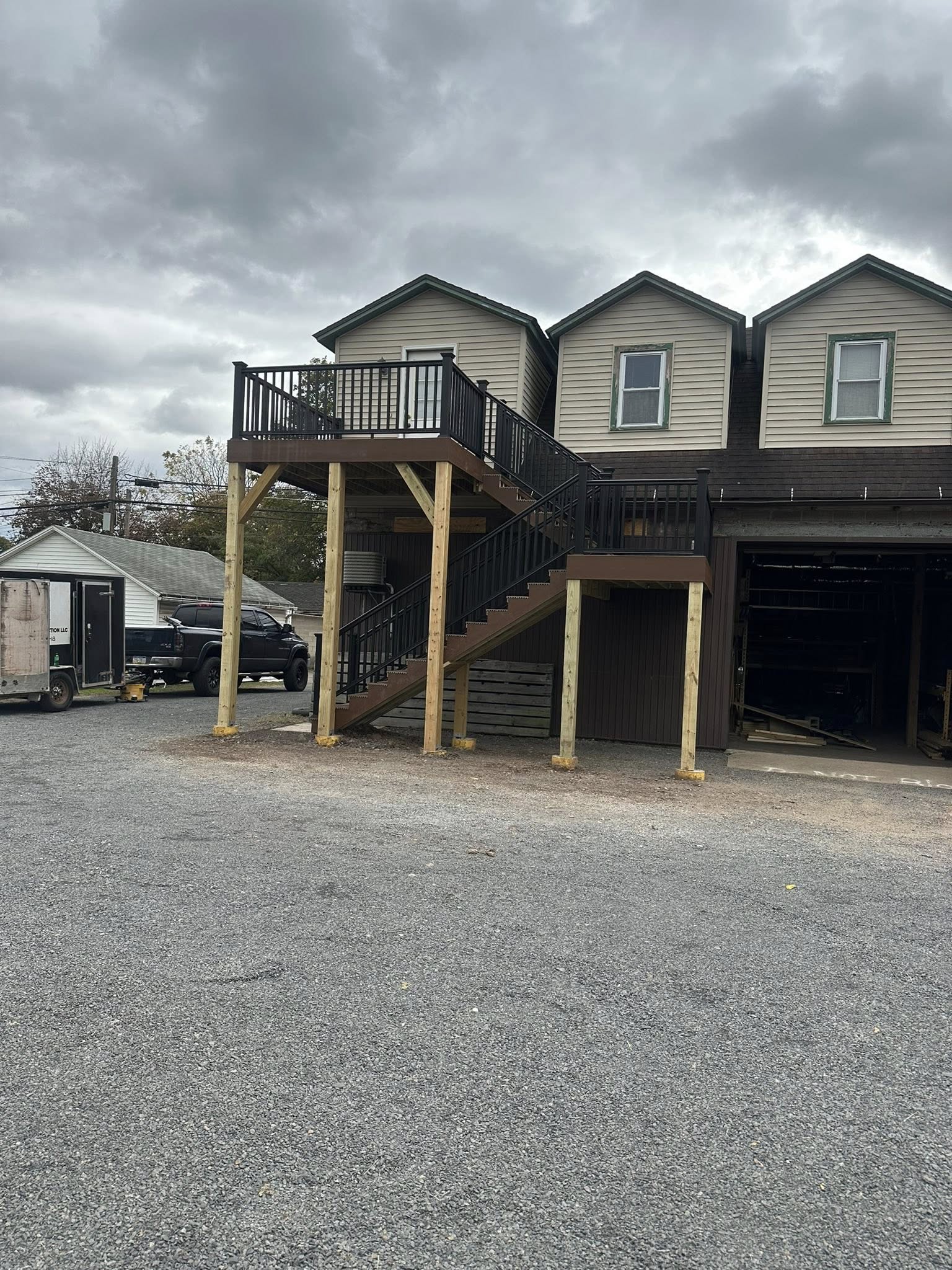 Elevated pressure-treated wood deck with stairs in Pennsylvania home.