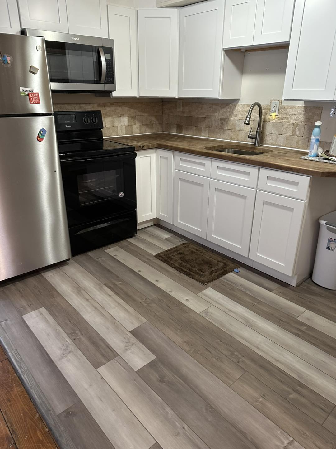 Farmhouse style kitchen with butcher block countertops.